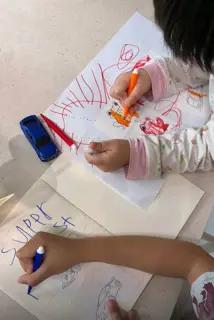 Customer photo: kids colouring Stickr prints of a fish and cars